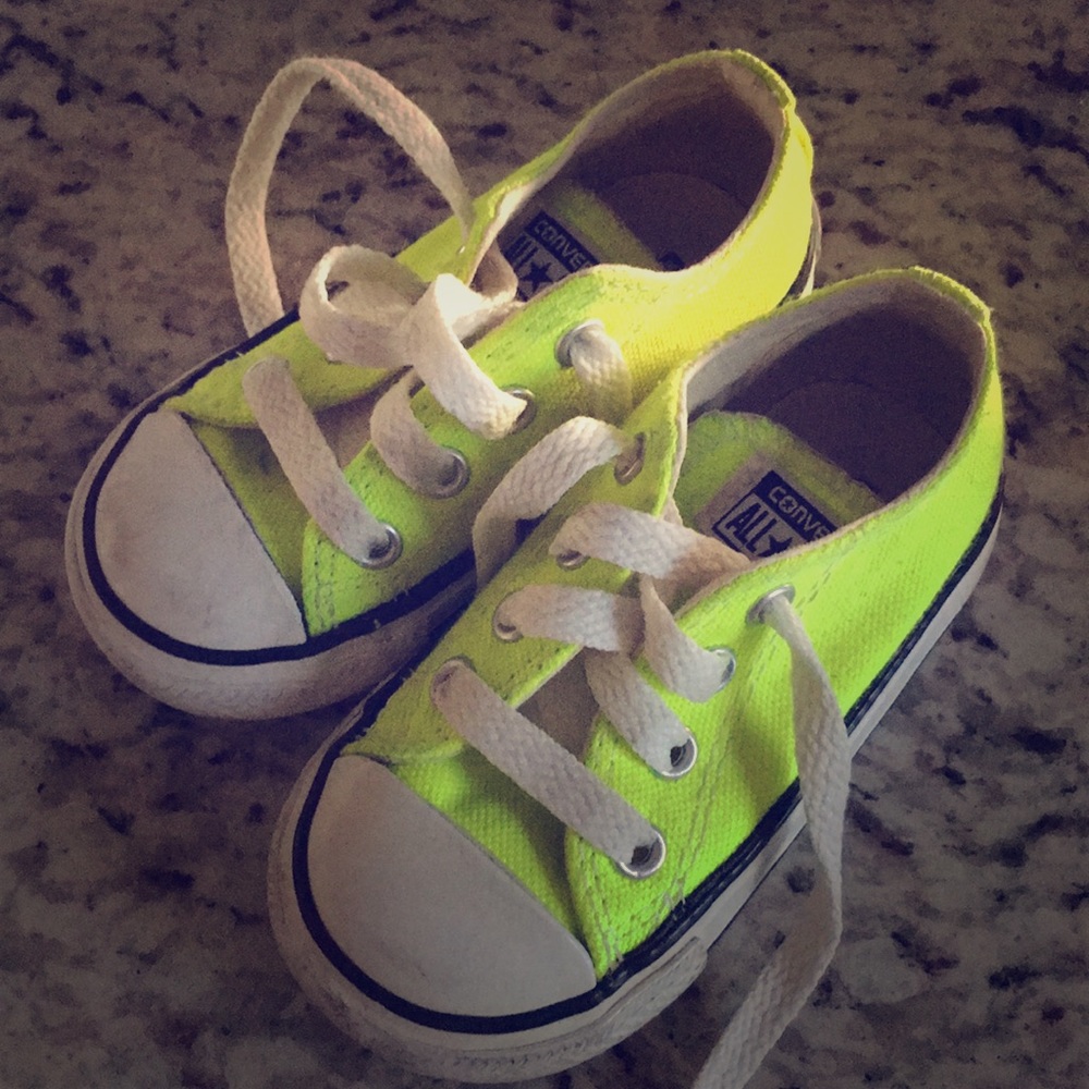 Gently used neon yellow converse sneakers.